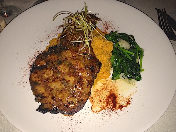 The Dining Room at Wolfgang Puck's Grand Cafe Downtown Disney pork chop entree image